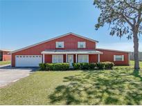 Charming two-story home with landscaped yard and attached two-car garage at 4230 Viola Rd, Lakeland, FL 33810