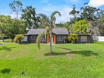 Charming single-story home boasts a large front yard, mature landscaping, and freshly painted facade at 504 Prado Pl, Lakeland, FL 33803