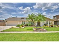 Charming single-story home featuring lush landscaping, a well-manicured lawn, and beautiful curb appeal at 5313 Nichols W Dr, Lakeland, FL 33812