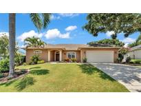 Charming single-story home with a well-manicured lawn and mature landscaping at 5548 Woodwind Hills Dr, Lakeland, FL 33812