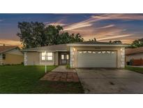 Charming single-story home featuring an attached two-car garage and a well-maintained front yard at 6406 Butternut Dr, Lakeland, FL 33813