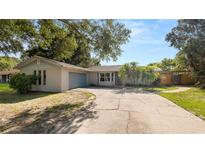 Charming single-story home with a well-maintained lawn and a driveway at 6421 Calusa Dr, Lakeland, FL 33813