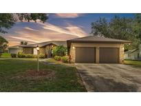 Charming single-story home with well-maintained landscaping and a two-car garage at 113 W Juliana Way, Auburndale, FL 33823