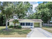 Charming single-story home featuring a landscaped front yard and driveway with a carport at 132 Kinstle Ave, Auburndale, FL 33823