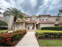 Inviting two-story townhome featuring well-maintained landscaping and a red tile roof at 443 Enclave Pl # 0, Lakeland, FL 33803