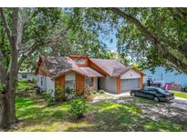 Attractive home showcasing the garage, shutters, landscaping, and front door at 4720 Wildflower Dr Dr, Lakeland, FL 33811