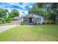 Charming single story home with well-manicured lawn and cozy front porch at 615 N Church Ave, Fort Meade, FL 33841