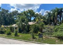 Charming home with a well-maintained lawn and mature tropical landscaping at 645 Avenue A Ne, Winter Haven, FL 33881
