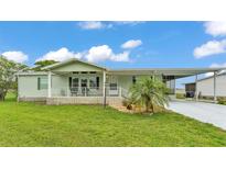 Charming single-story home with a well-manicured lawn and carport at 6509 Oak Hammock Ct, Winter Haven, FL 33884