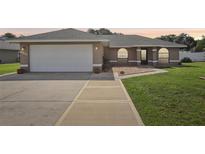 Charming single-story home featuring a two-car garage and well-maintained front yard at 8219 Rangers Path, Lakeland, FL 33809