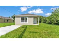 Charming single-story home featuring a well-manicured lawn and a freshly painted exterior at 1025 Lakewood Ct, Lakeland, FL 33801