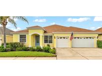 Charming single-story home featuring a well-manicured lawn, two-car garage, and a cheerful yellow facade at 2472 Tahoe Dr, Lakeland, FL 33805