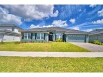 Charming single-story home with lush front lawn and beautifully landscaped front yard at 5298 Tennessee Ridge Ct, Auburndale, FL 33823