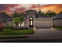 Charming home featuring manicured lawn, stone accents, and covered entryway at 6063 Stoney Creek Pl, Lakeland, FL 33811