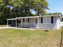 Gray house with carport and fenced yard at 313 S Ridgewood Ave, Deland, FL 32720