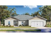 Charming single-story home featuring a two-car garage, neutral stucco, and a well-manicured front lawn at 402 Oliver Dr, New Smyrna Beach, FL 32168