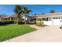 Charming single-story home featuring lush landscaping, a well-manicured lawn, and a welcoming walkway at 4606 Doris Dr, New Smyrna Beach, FL 32169