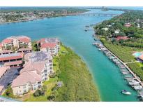 Aerial view of waterfront condo building near bridge and waterway at 434 Bouchelle Dr # 304, New Smyrna Beach, FL 32169