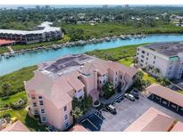 Aerial view of waterfront condo building with parking and boat slips at 434 Bouchelle Dr # 304, New Smyrna Beach, FL 32169