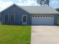 Charming single-story home featuring a well-maintained lawn and a two-car garage at 714 Fox Tail Ct, New Smyrna Beach, FL 32168