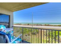 Relax on this condo balcony overlooking scenic ocean views and lush beach foliage at 3180 Ocean Shore Blvd # 208, Ormond Beach, FL 32176