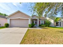 Charming single-story home with a well-maintained lawn and attached two-car garage at 1277 Harms Way, Port Orange, FL 32129