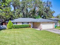 Brick ranch home with attached garage and well-manicured lawn at 628 10Th St, Daytona Beach, FL 32117