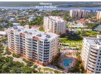 Stunning aerial view of beachfront condos with amenities including a pool, clubhouse, tennis courts and private beach access at 253 Minorca Beach Way # 205, New Smyrna Beach, FL 32169