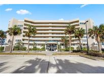 Stunning condo building featuring beautiful landscaping with palm trees and plenty of parking spaces at 4621 S Atlantic Ave # 7101, Ponce Inlet, FL 32127