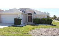 Charming single-story home with a well-manicured lawn and attached two-car garage at 537 Coral Trace Blvd, Edgewater, FL 32132