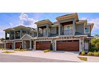 Three-unit townhome complex boasting modern design, two-car garages, and attractive landscaping at 2866 Isles Way, New Smyrna Beach, FL 32168