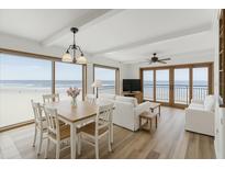 Bright living room with ocean views, modern furnishings, and hardwood floors at 4811 Saxon Dr # C102, New Smyrna Beach, FL 32169