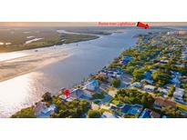 Aerial view showcasing a waterfront home near Ponce Inlet Lighthouse, with beach access nearby at 1324 N Peninsula Ave, New Smyrna Beach, FL 32169