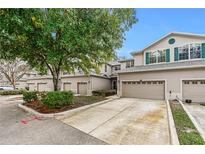 Tan two-story townhome with attached garage and landscaping at 137 Grey Widgeon Ct, Daytona Beach, FL 32119