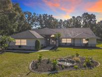 Single-story home with stone accents and landscaped yard at 2322 Melonie Trl, New Smyrna Beach, FL 32168