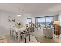 Oceanfront living room with dining area and balcony access at 4139 S Atlantic Ave # A307, New Smyrna Beach, FL 32169