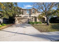 Two-story house with a driveway and attached garage at 6932 Vintage Ln, Port Orange, FL 32128