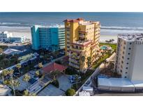 Aerial view of beachfront condo building with pool and ocean views at 701 N Atlantic Ave # 102, New Smyrna Beach, FL 32169