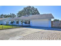 Light blue house with a white garage door and a well-maintained lawn at 752 Tarry Town Trl, Port Orange, FL 32127