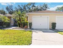 Exterior view of house with garage and driveway at 122 Turnbull Villas Cir, New Smyrna Beach, FL 32168