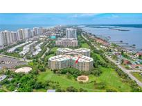 Aerial view of condo building showcasing ocean views and lush landscaping at 4 Oceans West Blvd # 502B, Daytona Beach, FL 32118