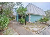 Exterior view of condo unit with walkway and landscaping at 4150 S Atlantic Ave # 112C, New Smyrna Beach, FL 32169