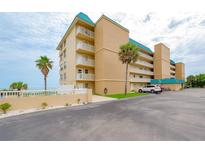 Oceanfront condo building with parking and tropical landscaping at 4799 S Atlantic Ave # 3030, Ponce Inlet, FL 32127