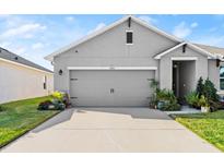 Charming single-Gathering home with a well-maintained lawn and gray two car garage at 5340 Bear Corn Run, Port Orange, FL 32128