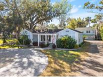 Charming light blue house with a spacious front yard and a brick driveway at 636 Faulkner St, New Smyrna Beach, FL 32168