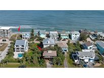 Aerial view of beach house community, showing home's location and proximity to the ocean at 6911 Turtlemound Rd, New Smyrna Beach, FL 32169