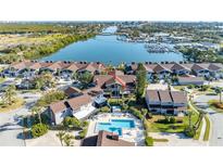 Aerial view of waterfront villas with pool and boat dock, showcasing community's waterfront access and amenities at 113 Lagoon Ct, New Smyrna Beach, FL 32169