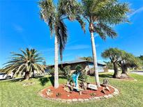 Cute ranch home with a landscaped yard, palm trees, and circular driveway at 1424 Breaks Way, Port Orange, FL 32127