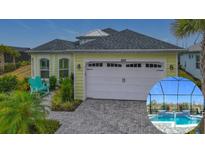 House exterior featuring a two-car garage and a captivating pool and patio area at 205 Blue Starfish Pl, Daytona Beach, FL 32124