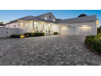 Stunning white two-story house with a large driveway and landscaping at 2302 S Atlantic Ave, New Smyrna Beach, FL 32169